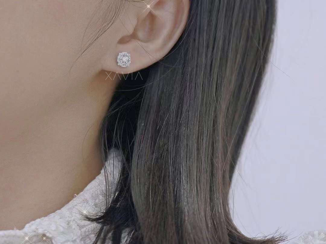 Model wearing bold geometric diamond stud earring on ear